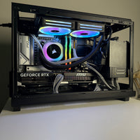 Open computer case with RGB lighting on a white surface